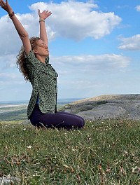 Gruop of women practicing yoga outdoors.